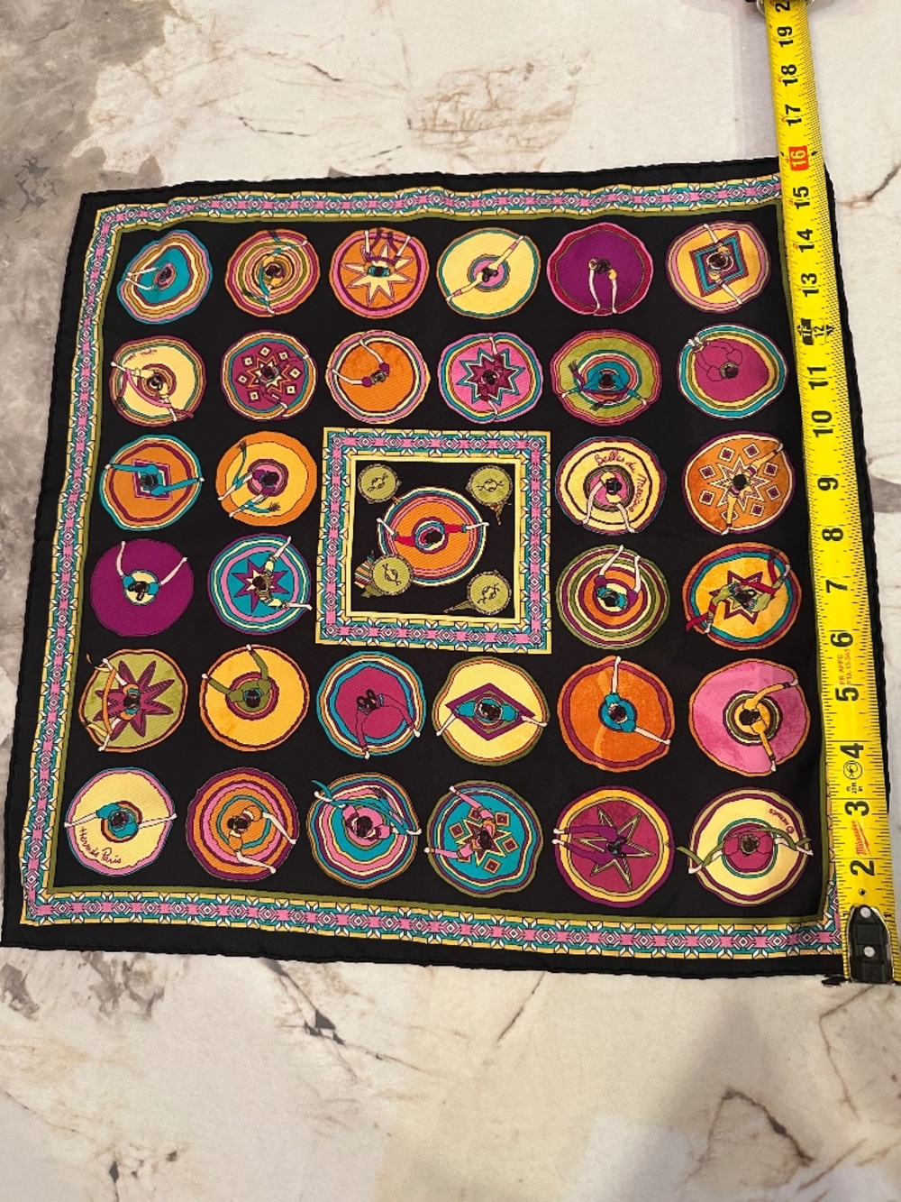 Hermès Paris silk scarf with multicolored circular and geometric designs on a bl